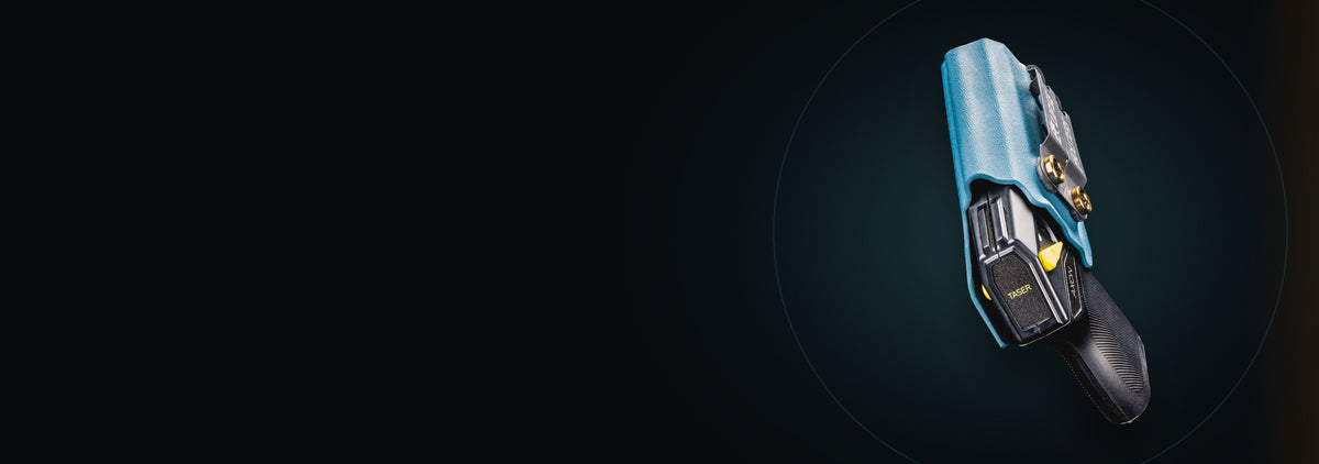 TASER Pulse 2 in a teal Eclipse custom holster on a dark studio background