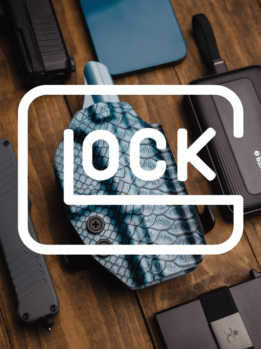 A close-up flat lay of a blue and black textured holster with a large white 'GLOCK' graphic overlay, surrounded by black tactical gear on a wooden surface.